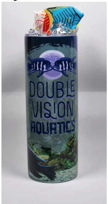 African Cichlid tumbler — dark aquarium scene wrap with the DVA logo and fish figures on the lid