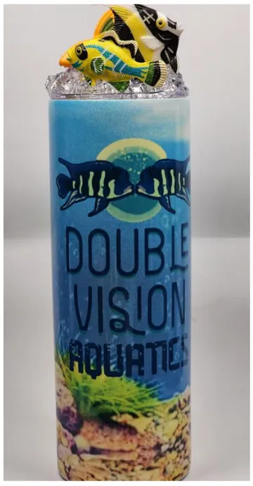 Sunburst tumbler — sunlit underwater scene wrap with the DVA logo and tropical fish figures on the lid